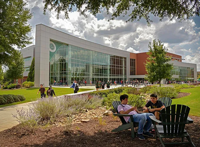 students between classes in front of the library