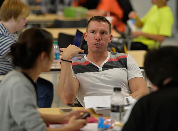 GGC students talking around the table in the atrium