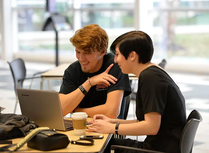 GGC students studying over laptop