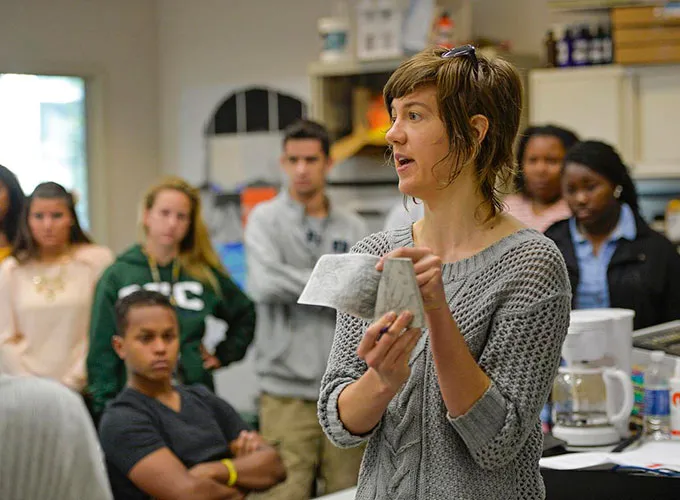 Faculty member teaching class among attentive students