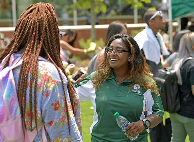 SGA member greeting new Grizzly at first day of class event