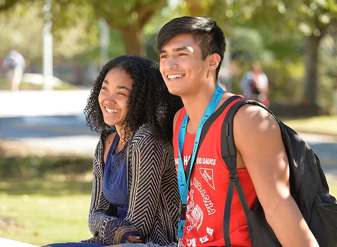 students seated outdoors on a sunny day