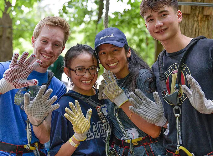 Honors student waving during zipline outing