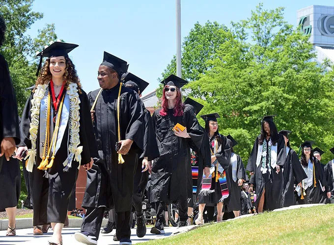 GGC grads lined up and walking to graduate