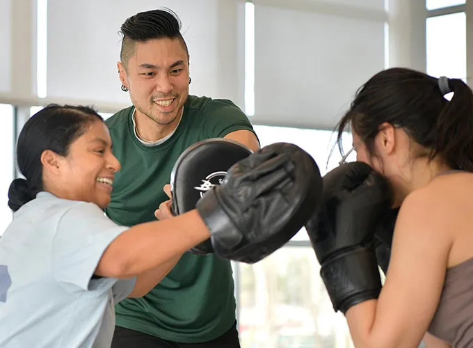 Students participating in a Wellness and Recreation Center boxing lesson 