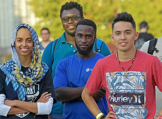 Group of diverse students pausing for an outside photo