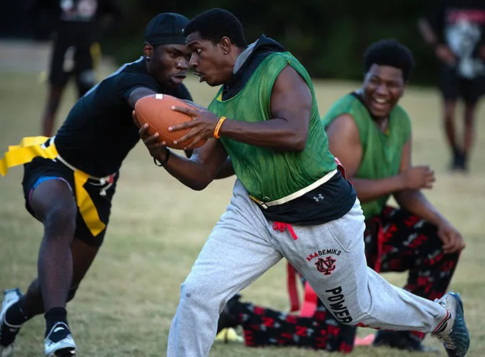 Students competing in a flag football game