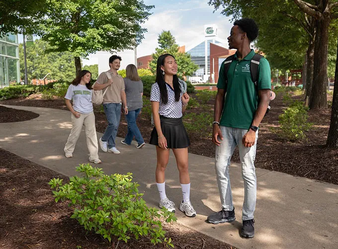 GGC students between classes walking near the library