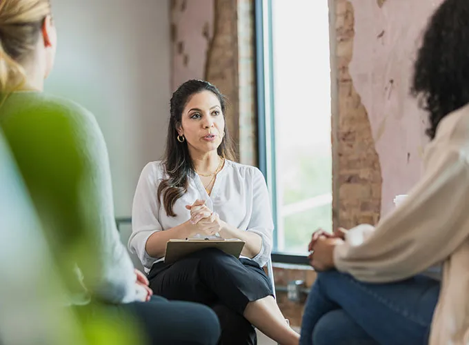 Three women talking during a therapy session