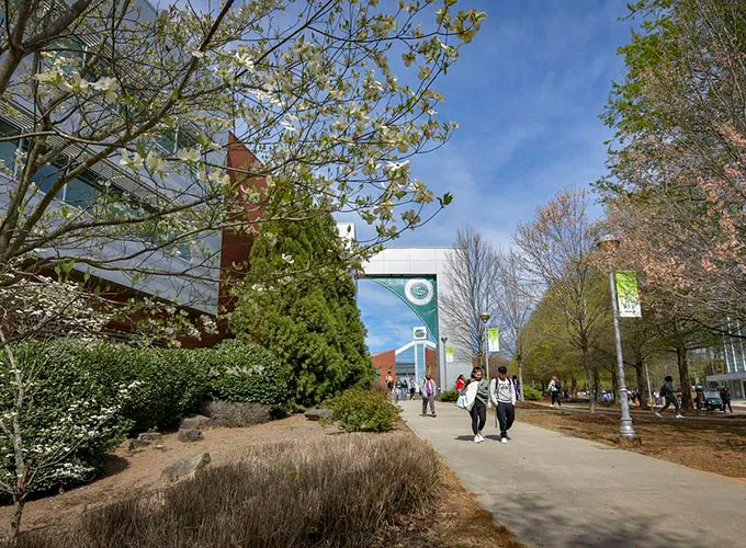 students walking near library in early spring