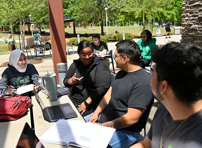 students studying under outdoor pergola