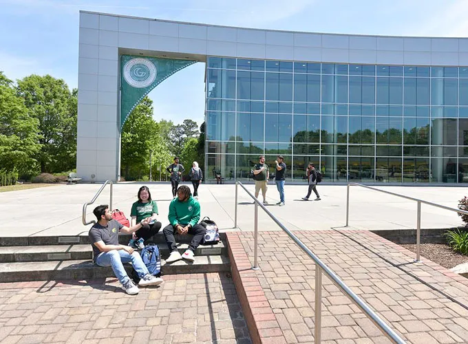 student socializing in front of the library