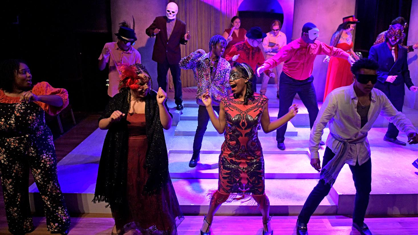 group of male and female students singing in a performance
