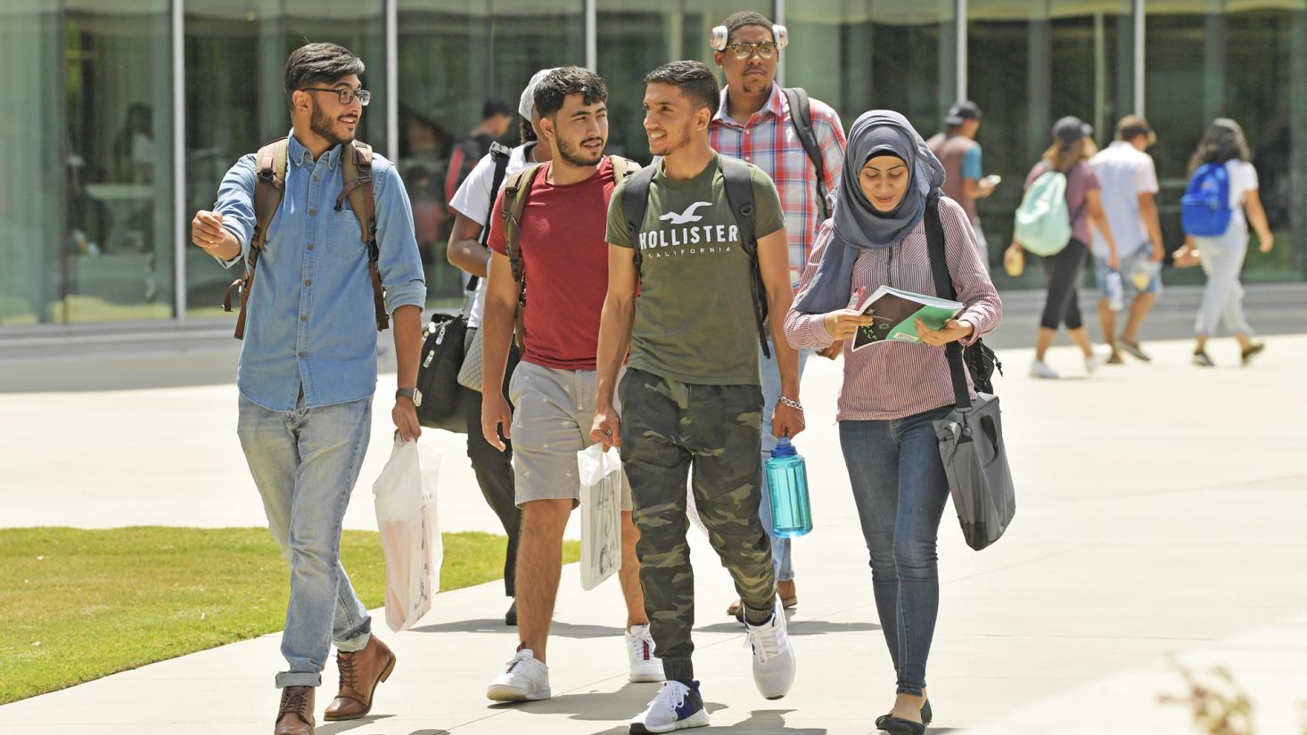 Students walking on sidewalk