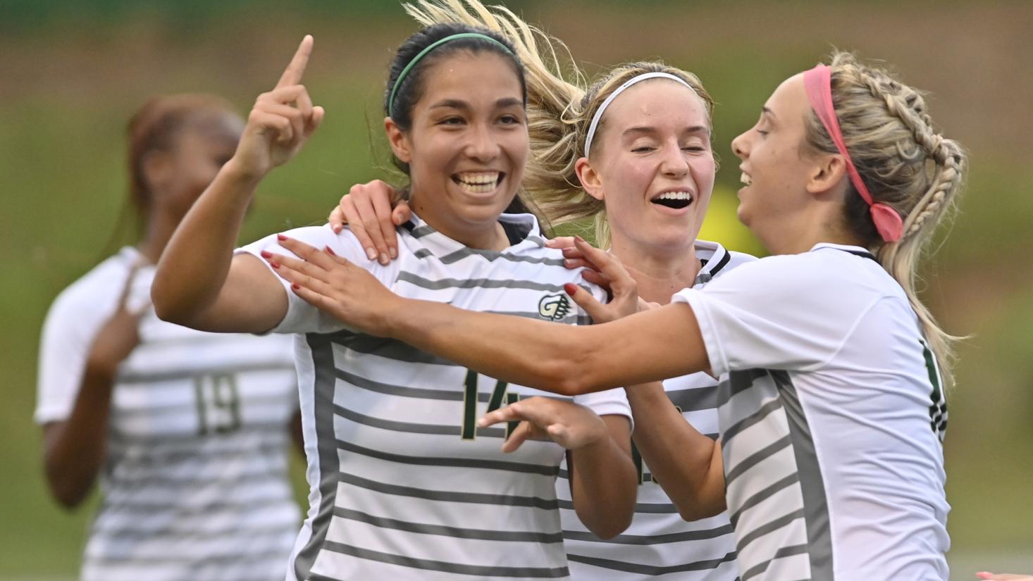 Female soccer players celebrating