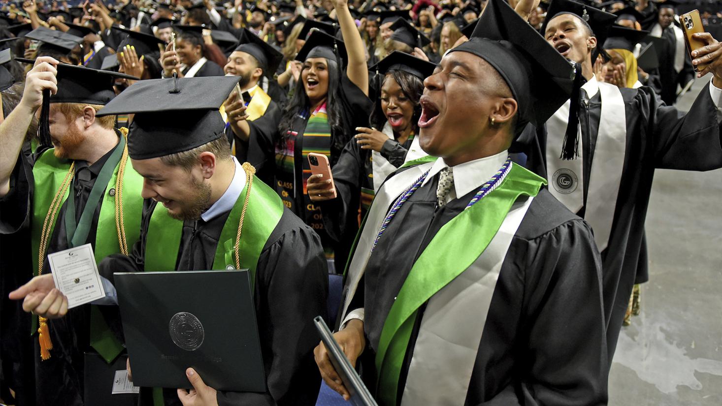 Students in caps and gowns celebrating graduation