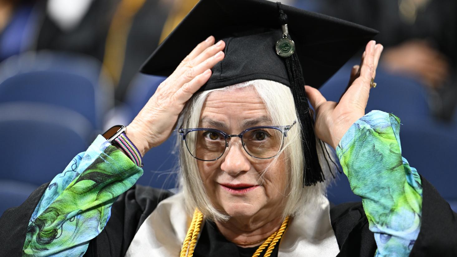 Woman adjusting her graduation cap