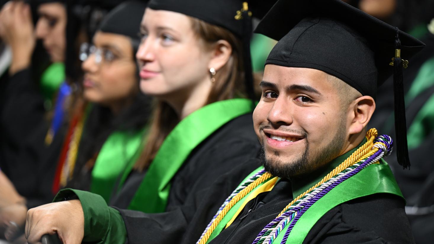 Male graduate smiling at camera