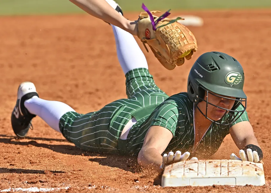 softball player sliding into home base