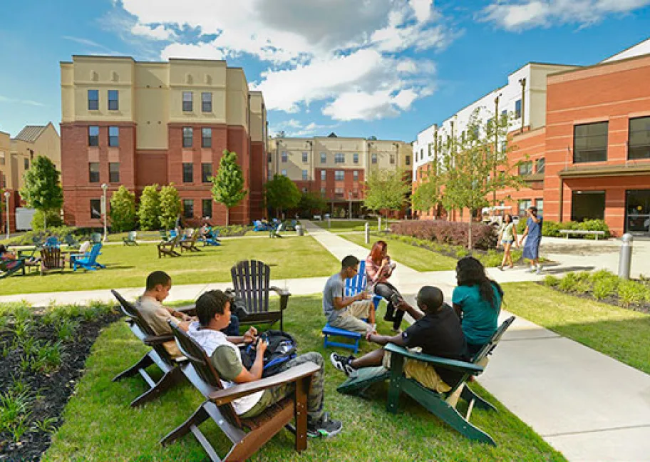 Resident Grizzlies socializing in Adirondack chairs in housing courtyard