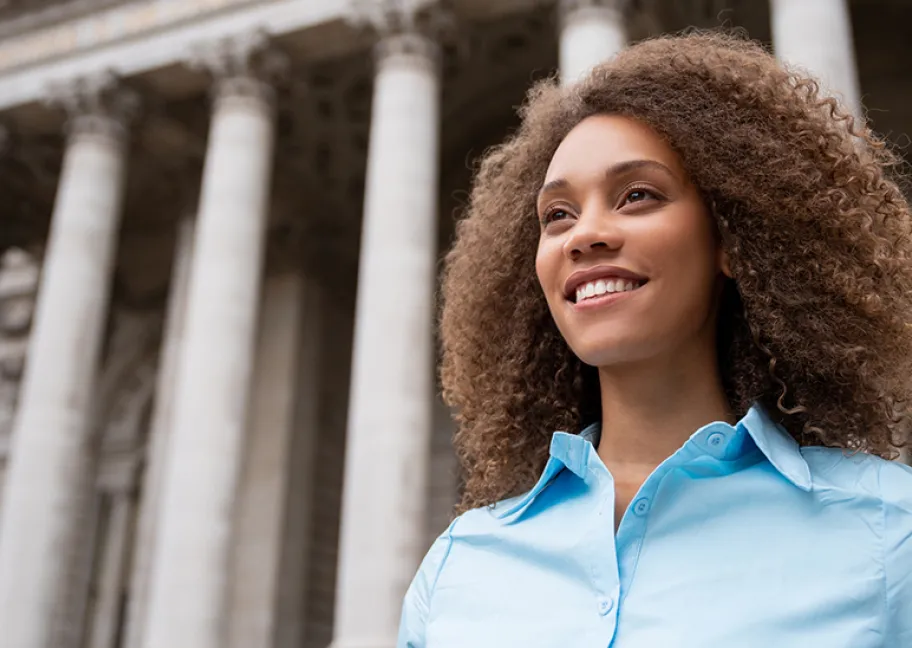 Female student in front of columned government building