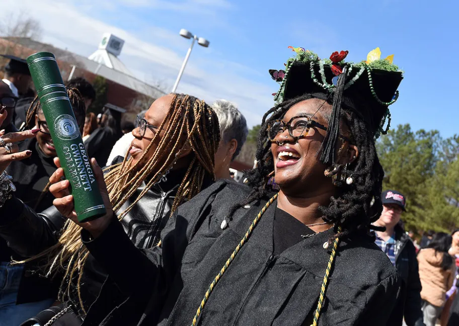 GGC grads celebrating outside after ceremony