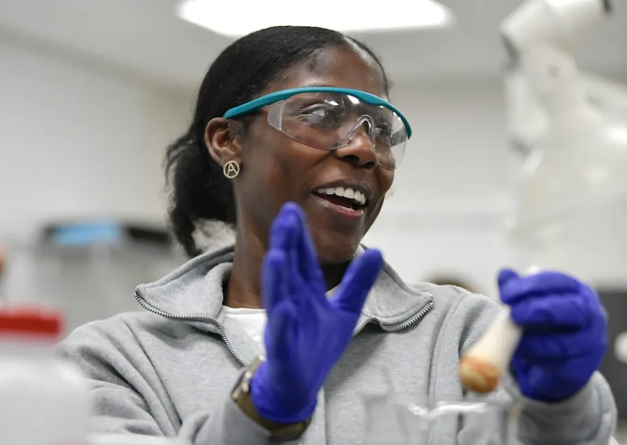 Student with test tube in science lab
