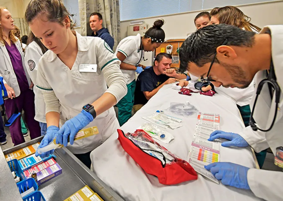 Nursing majors assisting a patient during a mock exercise