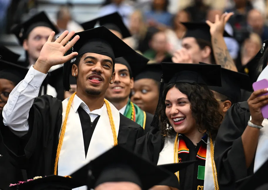Male and female graduate smiling