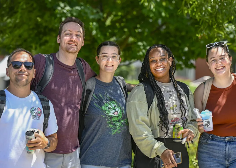 Group of male and female students smiling at the camera