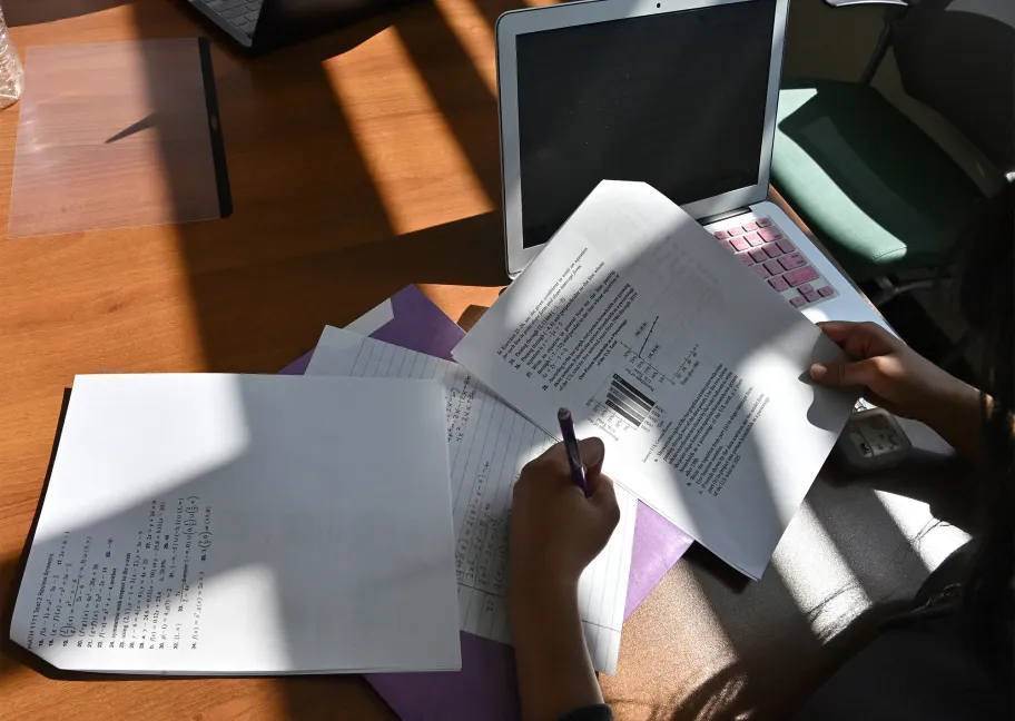 Student writing on a paper