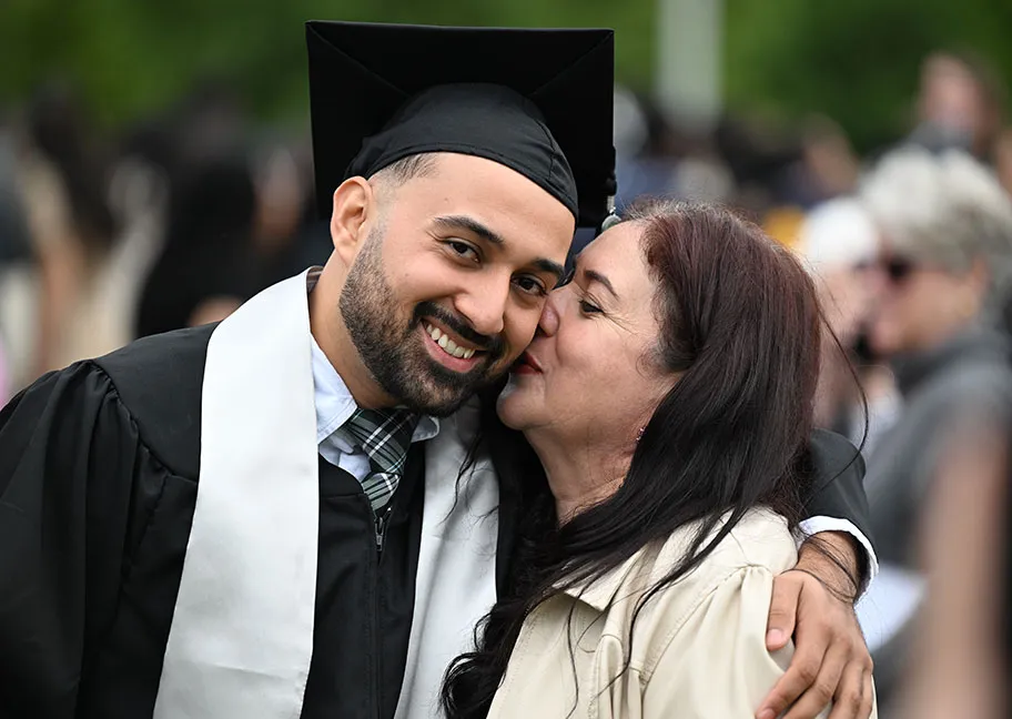 GGC graduate's proud moment hugging family member