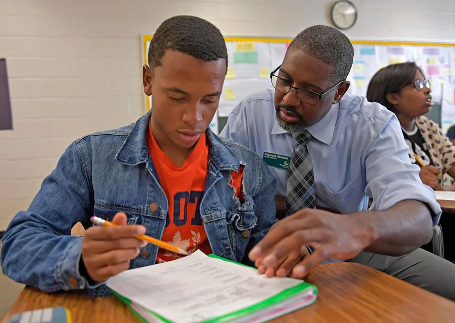 GGC student helping a high school student during and in-class teaching experience