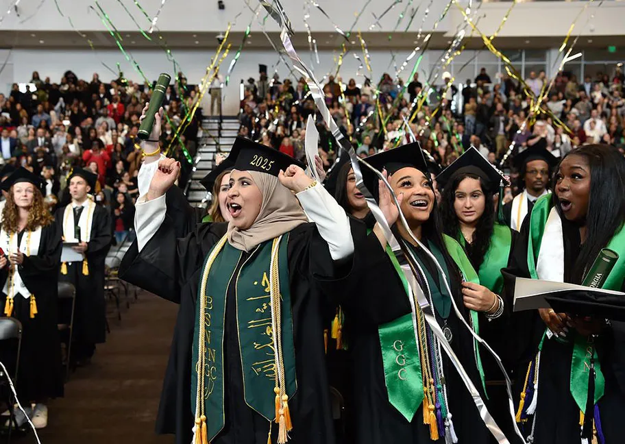 Cheering grads at the close of the ceremony with falling streamers