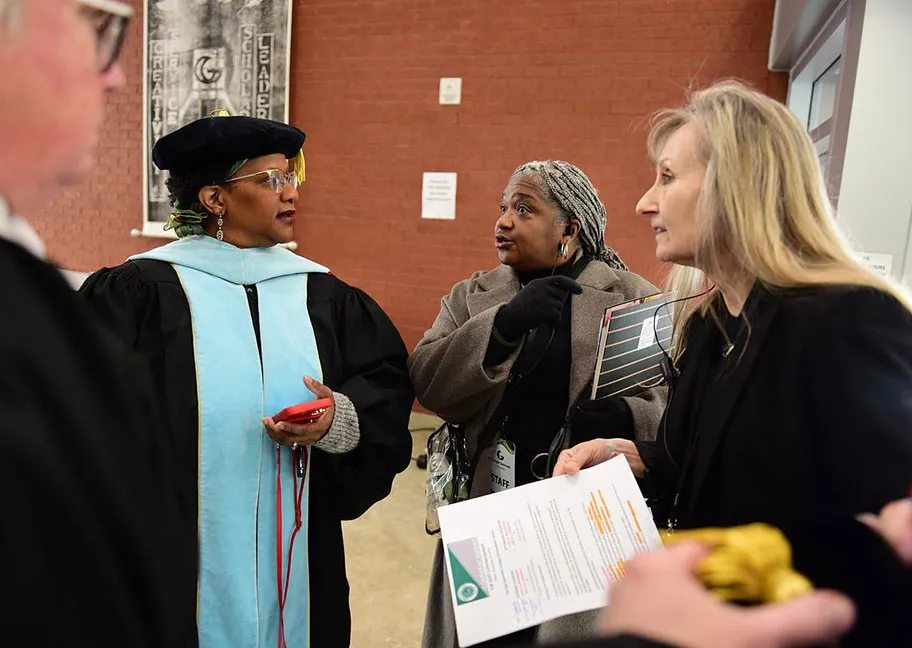 Commencement staff speaking with faculty