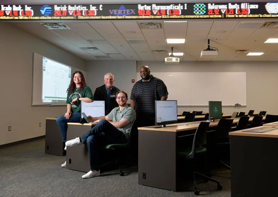 Faculty and students seated in new SBA sims lab