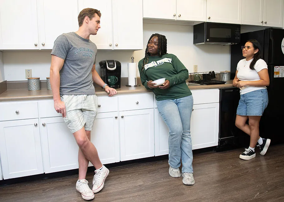Student residents chatting in Student Housing suite kitchen