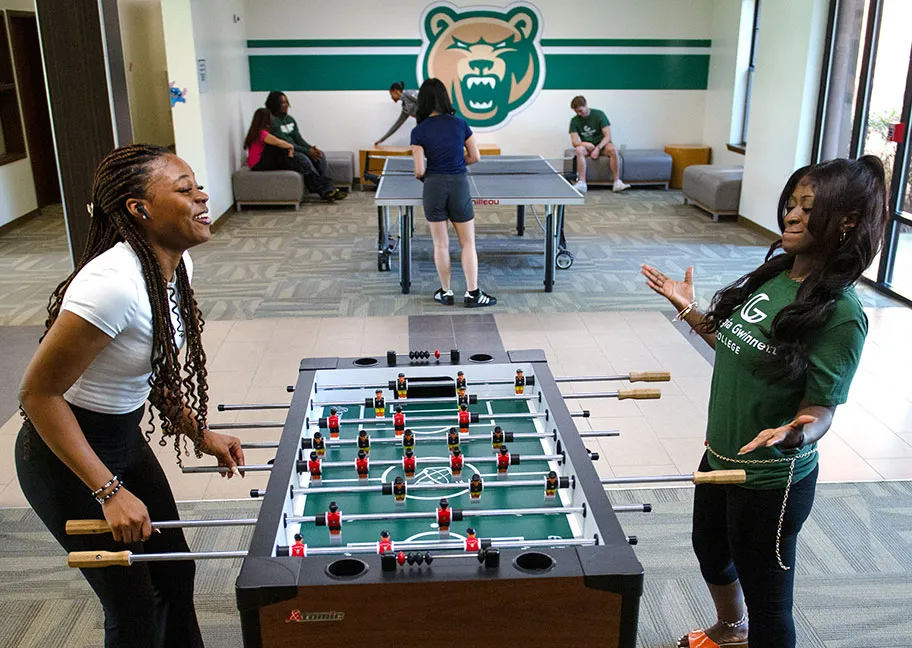 Student residents playing foosball in the student housing game room.