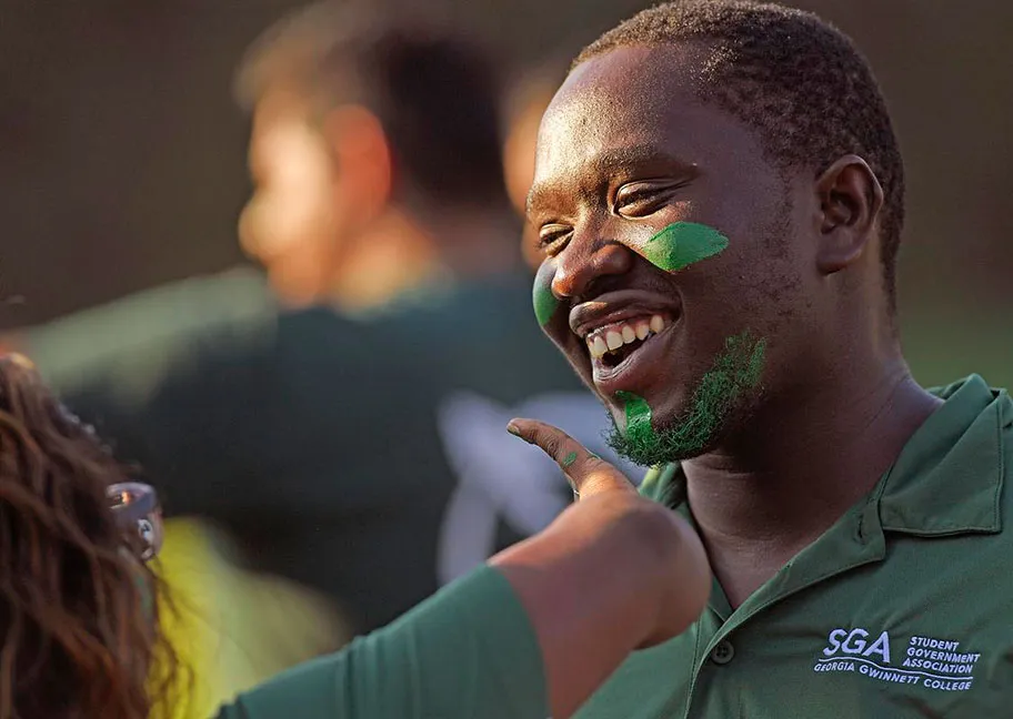 GGC spirited student getting green face paint