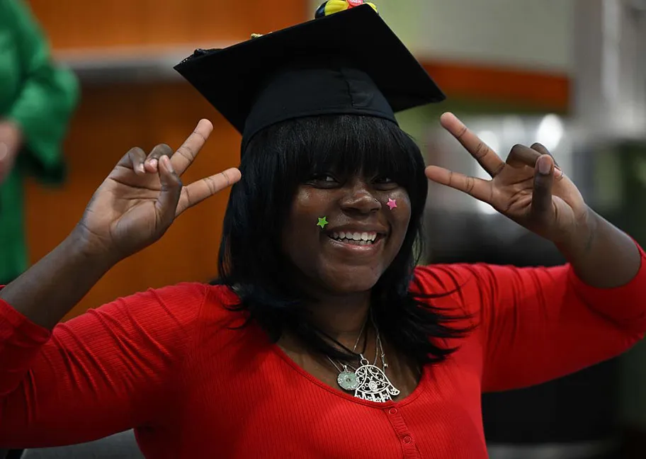 GGC senior gesturing with peace signs at Senior Sendoff event
