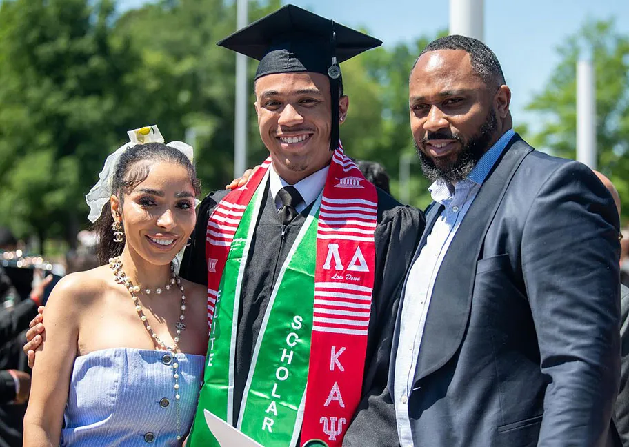 family posing with grad outside at commencement
