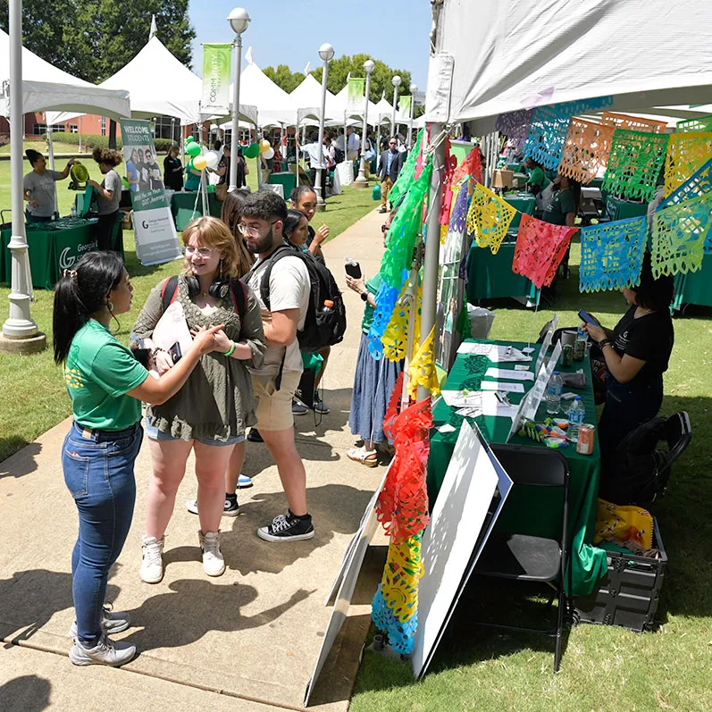 students browsing club memberships at outdoor tabling event