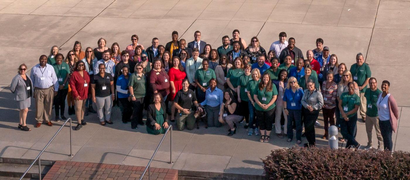 Staff council group in front of the library