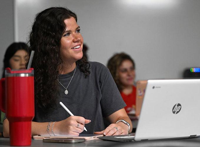 Engaged student taking notes during class