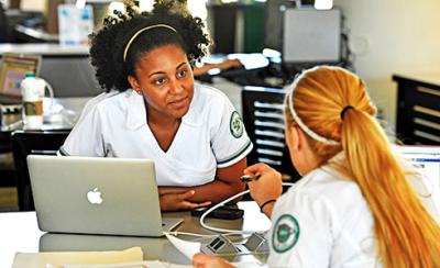 Nursing student discussion with laptop