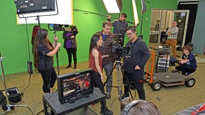 Students looking at video camera.