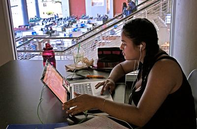 student studying in a second-floor library study room