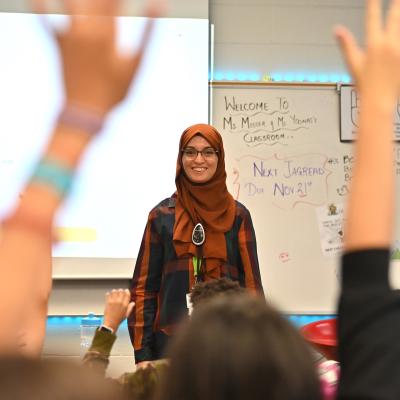 Teacher looking at hands raised in class