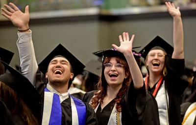 GGC graduates celebrating and waving at commencement