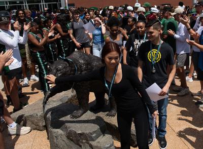 GGC freshmen participating in the good-luck tradition of touch the statue of the college's mascot, General.